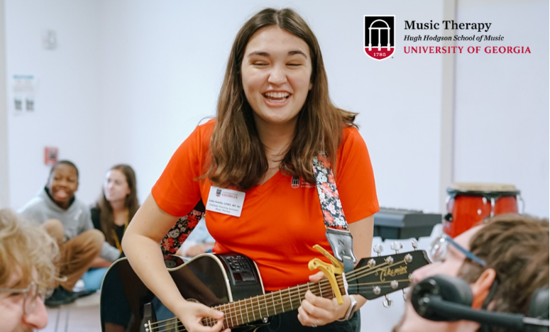 Music Therapist playing guitar in a music therapy session.