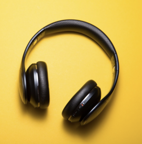 A pair of headphones on a yellow background