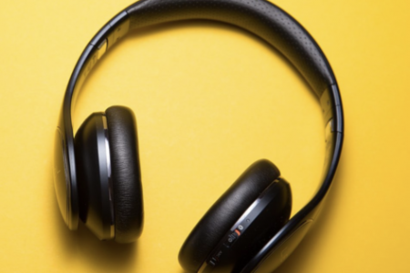 A pair of headphones on a yellow background